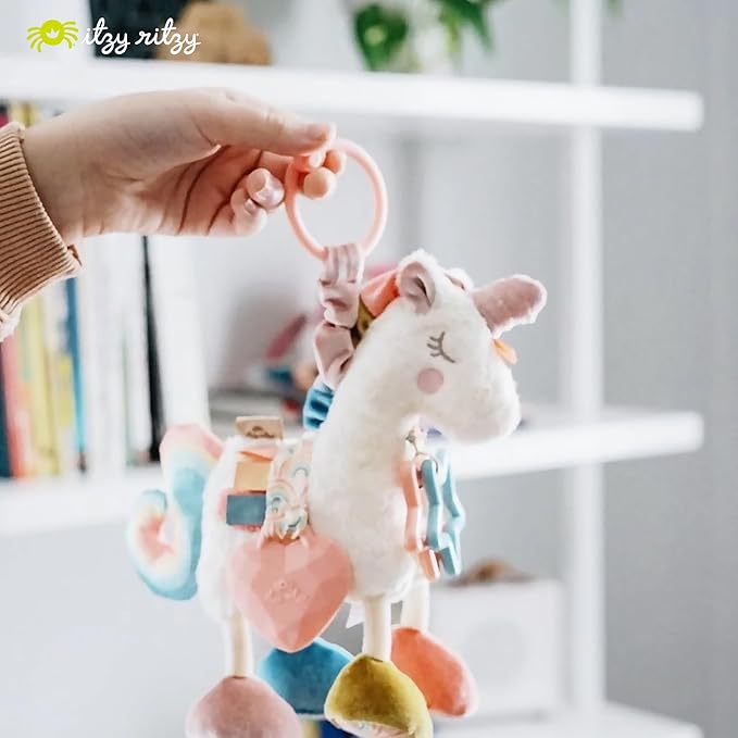 Itzy Ritzy Link & Love Toy for Stroller or Car Seat; Features Textured Ribbons, Crinkle Sounds, Clinking Rings & Silicone Teether; Designed For Ages 0 Months and Up (Unicorn)