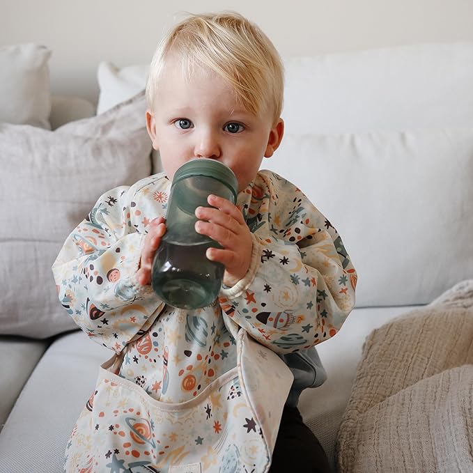 mushie Long Sleeve Baby Bib | Water Resistant Adjustable Fit for Ages 6-24 Months